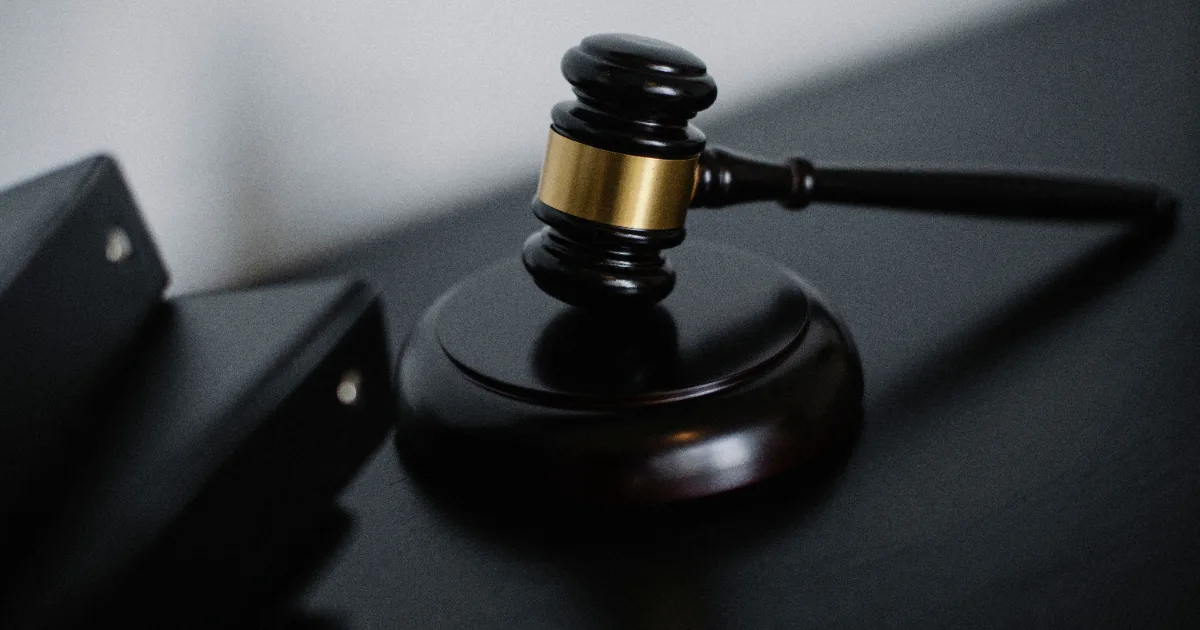 A wooden gavel and sound block on a dark desk representing Congressional legislation and policymaking on ACA premium tax credit extensions