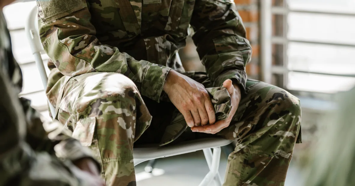US service member in camouflage uniform sitting down, representing GI Bill Monthly Housing Allowance (MHA) calculation